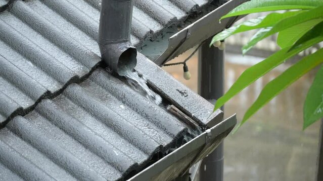 4K scene of rainy season, heavy rain water downpour on gutter roof house