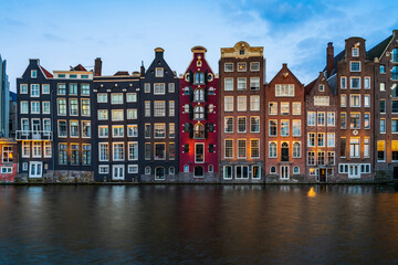 Naklejka premium Typical dutch houses by the canal in Amsterdam, Holland
