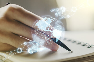 Creative abstract robotics technology sketch with globe and man hand writing in notepad on background, future technology and AI concept. Double exposure