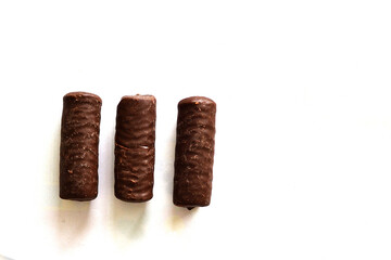 Three chocolate bars lie on a white background