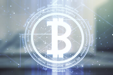 Double exposure of creative Bitcoin symbol hologram on modern business center exterior background. Cryptocurrency concept
