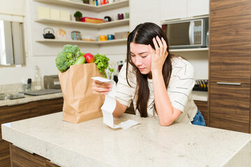 Stressed woman worried about expensive groceries