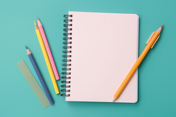 Top view pastel notebook with pencil and stationery on navy blue table background