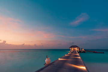 Amazing sunset landscape. Picturesque summer sunset in Maldives. Luxury resort villas seascape with...