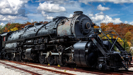 old locomotive in the countryside under a cloudy sky