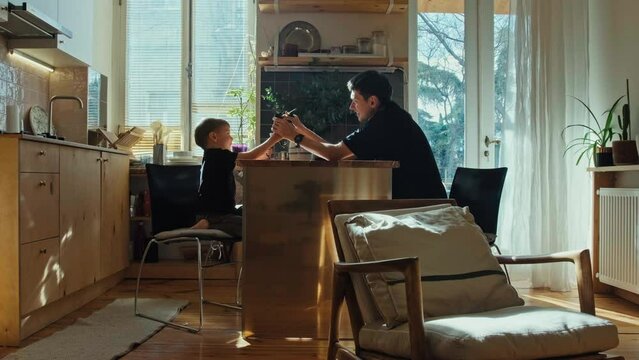Father and son play with toys. Parents and children.