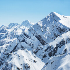 Naklejka premium Beautiful snowy peaks of the Caucasus Mountains. Krasnaya Polyana Rosa Khutor Ski Resort, Russia.