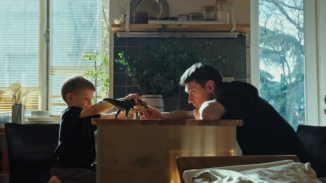 Father and son play with toys. Parents and children.