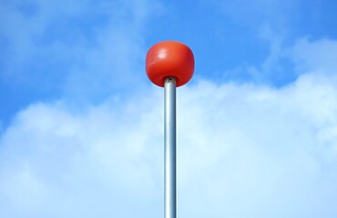 Orange balloon on the mast of the yacht