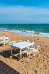 dinning table and chair on beach with sea background