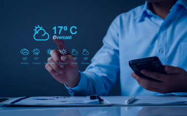 Hands holding smartphone with Weather forecast widget concept. cloudy, rainy and sunny day concept, touchscreen device with different seasons and daily temperature. Weather forecast for every day.