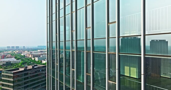 Aerial view of commercial office building glass wall and urban skyline scenery