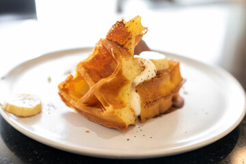 Waffle with chocolate ice cream, crumble and fresh whipping cream.