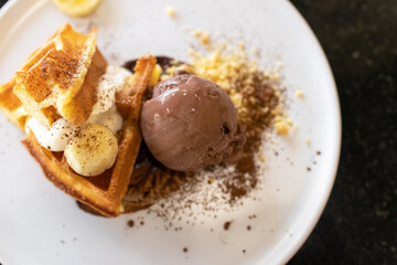 Waffle with chocolate ice cream, crumble and fresh whipping cream.