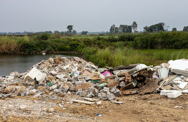 Scenery of piles of concrete debris and white tiled ceilings being dumped together.