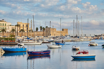 Fototapeta na wymiar Bari town skyline and fishing boats - harbor in Apulia region.