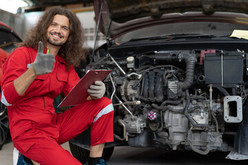 Fototapeta na wymiar Auto mechanic working in vehicle repair service garage. Handsome long hair repairman inspection broken car engine, damage motor, dirty part and fix. People in automotive maintenance business concept