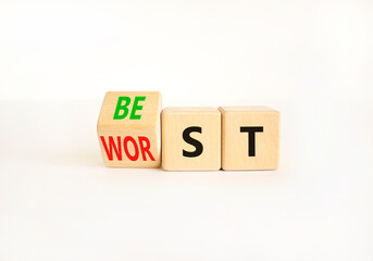 Best or worst symbol. Businessman turns wooden cubes and changes the word best to worst. Beautiful...