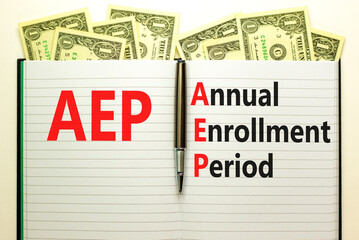 AEP symbol. Concept words AEP Annual enrollment period on beautiful white note. Dollar bills....