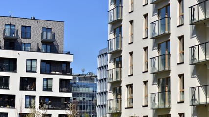 Modern apartment buildings on a sunny day with a blue sky. Facade of a modern apartment building. Contemporary residential building exterior in the daylight. 