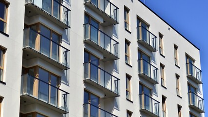 Modern apartment buildings on a sunny day with a blue sky. Facade of a modern apartment building. Contemporary residential building exterior in the daylight. 