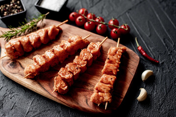 raw turkey skewers
on a stone background