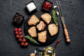 Schnitzel Cordon Bleu fillet cutlet with ham and cheese on a stone background
