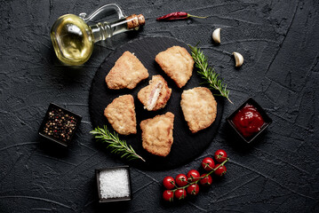 Fototapeta na wymiar Schnitzel Cordon Bleu fillet cutlet with ham and cheese on a stone background