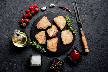 Schnitzel Cordon Bleu fillet cutlet with ham and cheese on a stone background