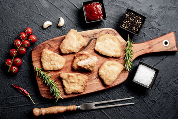 Schnitzel Cordon Bleu fillet cutlet with ham and cheese on a stone background