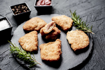 Schnitzel Cordon Bleu fillet cutlet with ham and cheese on a stone background