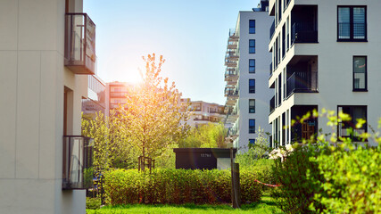 Ecology and green living in city, urban environment concept. Modern apartment building and green...