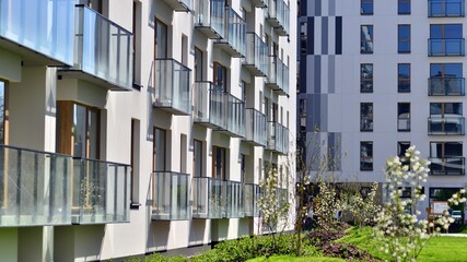 Modern apartment buildings on a sunny day with a blue sky. Facade of a modern apartment building. Contemporary residential building exterior in the daylight. 