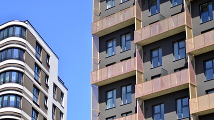 Modern apartment buildings on a sunny day with a blue sky. Facade of a modern apartment building. Contemporary residential building exterior in the daylight. 