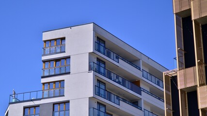 Modern apartment buildings on a sunny day with a blue sky. Facade of a modern apartment building. Contemporary residential building exterior in the daylight. 