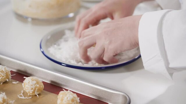 Scooping cookie dough into the baking sheet to bake coconut cookies. Generative AI