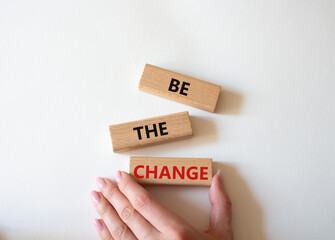 Be the change symbol. Concept word Be the change on wooden blocks. Businessman hand. Beautiful white background. Business and Be the change concept. Copy space