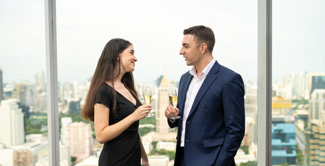 Happy couple with a glass of wine in bar indoors. Young man and woman on date in restaurant