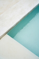 Swimming pool in modern, minimal, white Villa in Bali. Bohemian(Boho) and Scandinavian rustic home interior, white villa, modern luxury villa. Modern exterior and interior design. Aesthetic minimalist