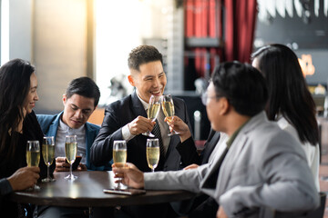 Group Of Asian Friends Enjoying Evening Drinks in bar. Celebration, Party People Christmas and Happy new year concept. Asian business people in party.