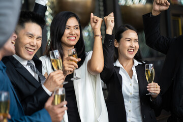 Group Of Asian Friends Enjoying Evening Drinks in bar. Celebration, Party People Christmas and Happy new year concept. Asian business people in party.