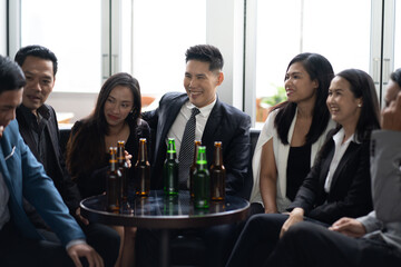 Group Of Asian Friends Enjoying Evening Drinks in bar. Celebration, Party People Christmas and Happy new year concept. Asian business people in party.