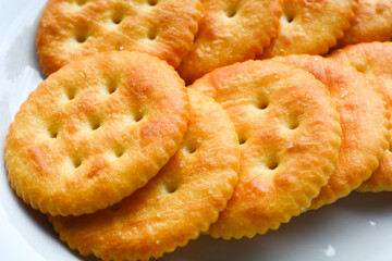 Round-shaped pastries placed on a pure white porcelain plate. Flat lay photography