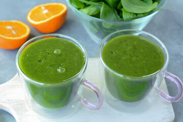 Fresh spinach, banana and orange fruit smoothie. Detox green drink