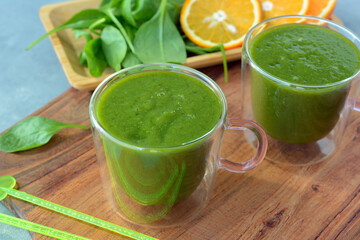 Fresh spinach, banana and orange fruit smoothie. Detox green drink