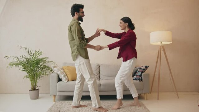 Happy loving couple having fun in kitchen, dancing together Generative AI