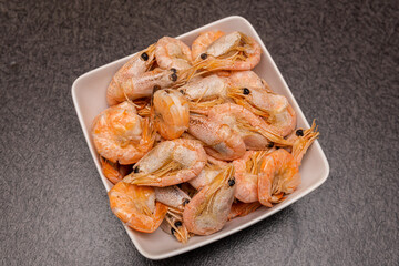 A lot of big shrimps, prawns in the plate on the table