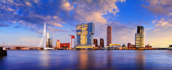 Evening cityscape, panorama, banner - view of Rotterdam with Tower blocks in the Kop van Zuid neighbourhood and Erasmus Bridge, The Netherlands - obrazy, fototapety, plakaty