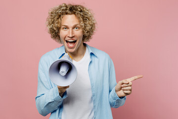 Young excited blond man wear blue shirt white t-shirt hold in hand megaphone scream announces...