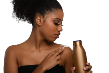 a woman applying moisturizing cream to her skin, smiling while holding a bottle demonstrating skin care